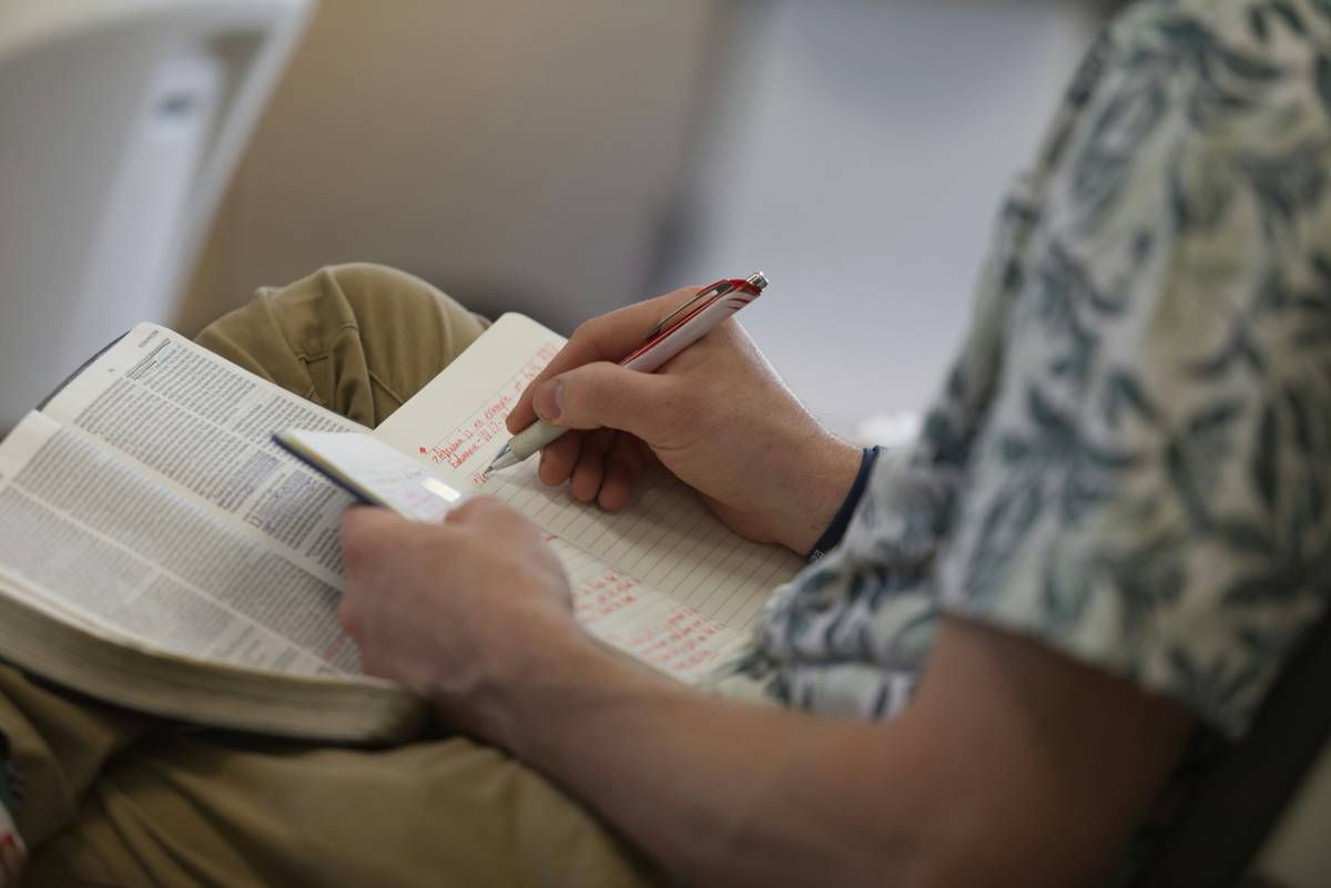 Student reviewing biology mcat practice questions with highlighted errors in a notebook